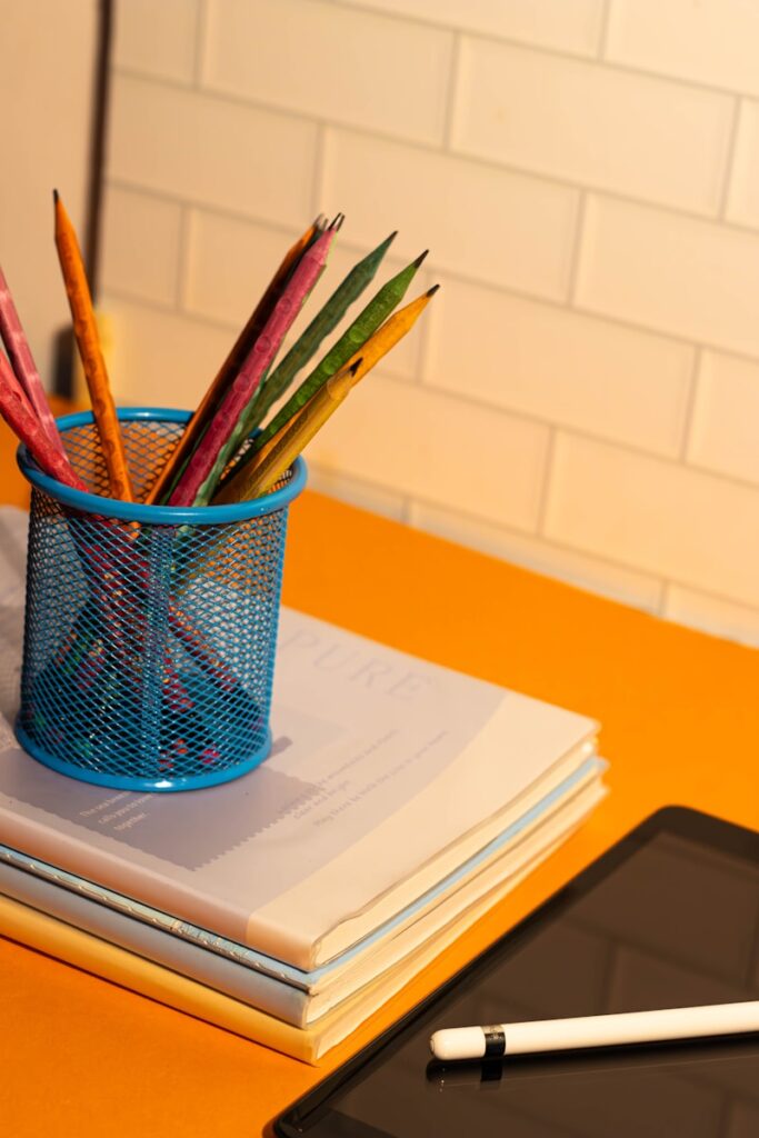 A cup of pencils and a tablet on a table